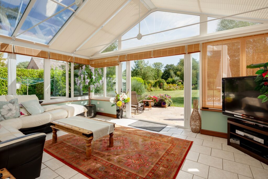 conservatory roof blinds in a large white timber conservatory