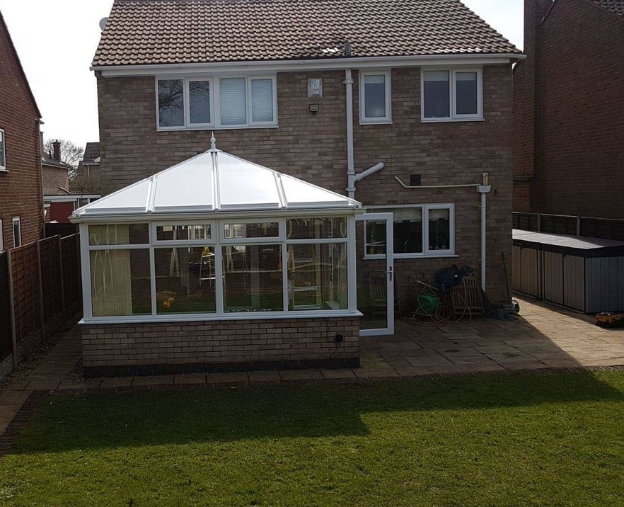 Conservatory refurbishment in Staffordshire showing a detached home with a white conservatory
