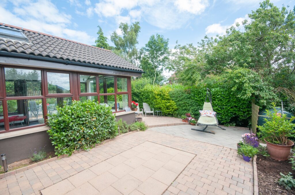 conservatory roof condensation article showing a tiled conservatory roof and patio area